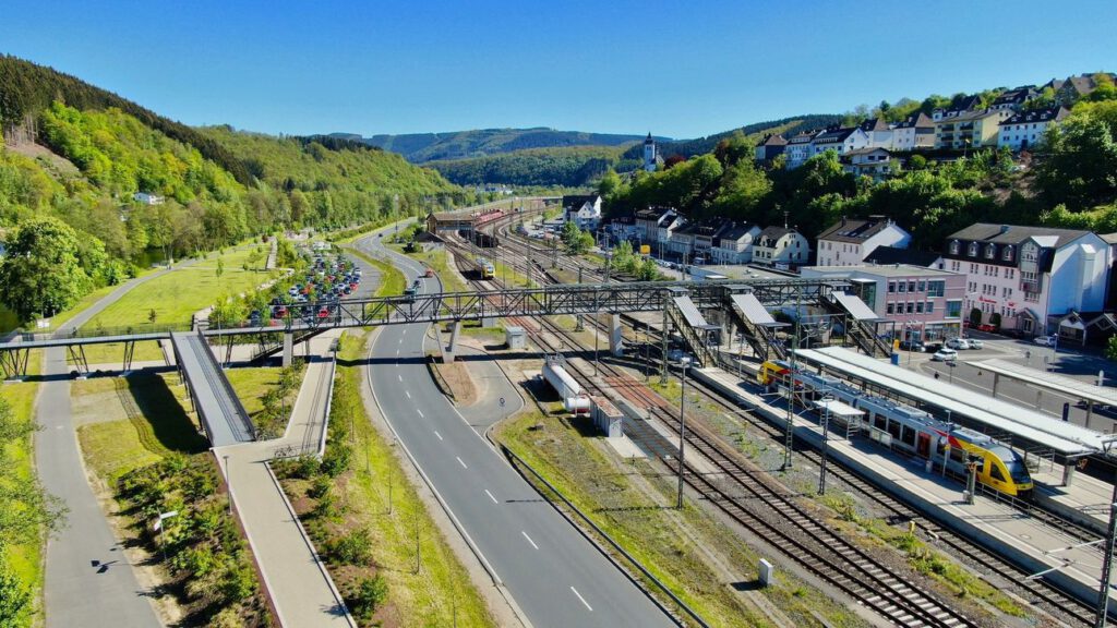 Blick auf einen Bahnübergang, Gleise und eine Straße